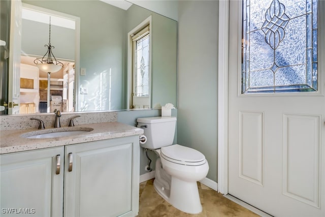 bathroom with tile patterned flooring, toilet, and vanity