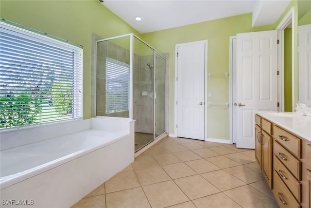 bathroom with vanity, tile patterned floors, and plus walk in shower