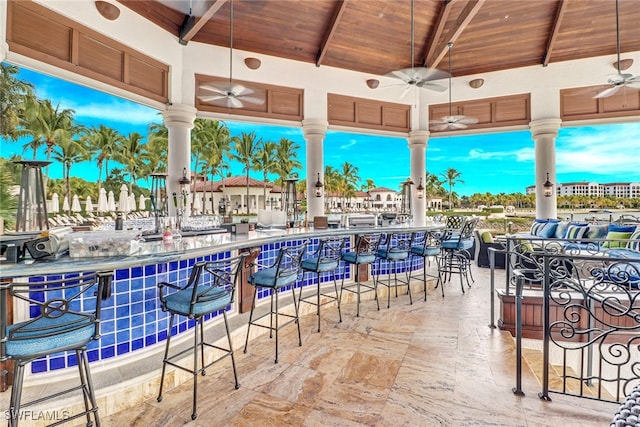 view of patio featuring a bar and ceiling fan