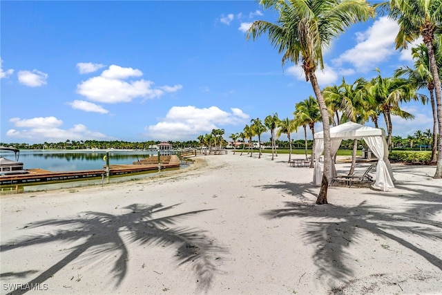 exterior space with a water view, a dock, and a gazebo