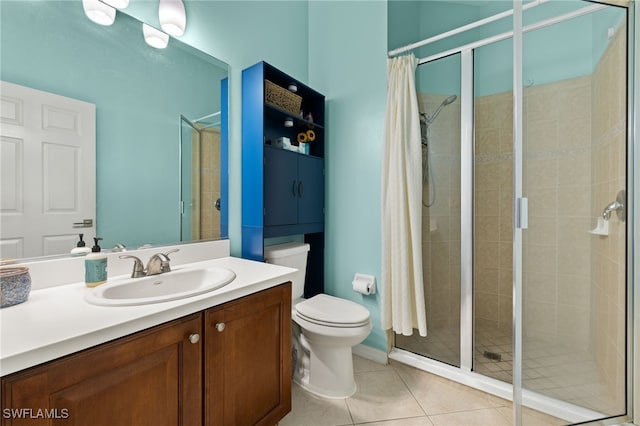 bathroom featuring tile patterned floors, a tile shower, vanity, and toilet