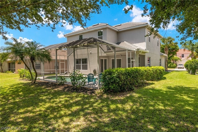 rear view of house with a lanai and a lawn