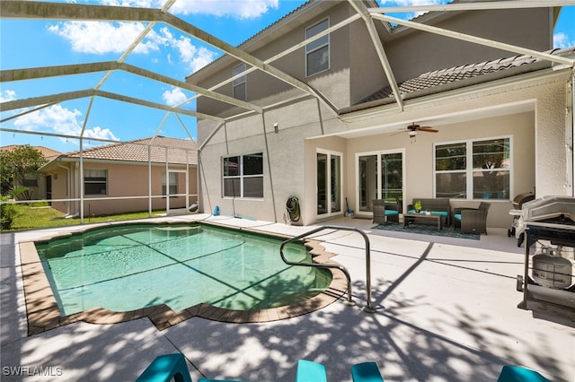 view of pool featuring ceiling fan, outdoor lounge area, a patio area, and a lanai