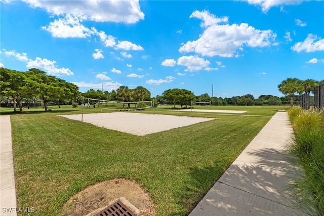 surrounding community featuring a lawn and volleyball court