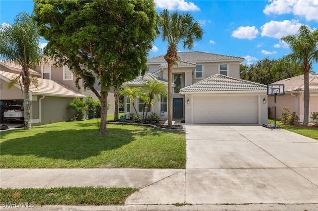 mediterranean / spanish-style home featuring a garage and a front lawn