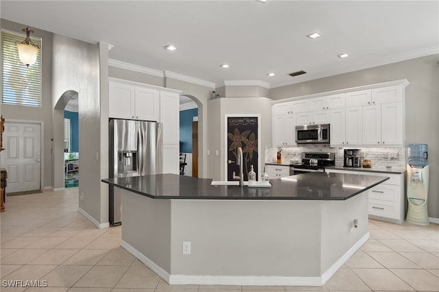 kitchen featuring a center island with sink, stainless steel appliances, white cabinets, and sink