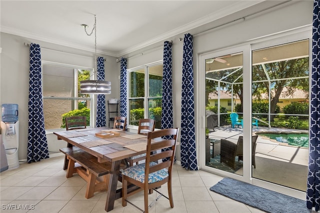 dining area featuring crown molding and light tile patterned floors