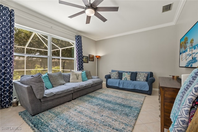 tiled living room with ceiling fan and crown molding