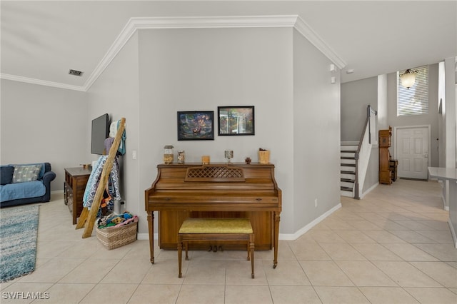 miscellaneous room with a high ceiling, crown molding, and light tile patterned floors