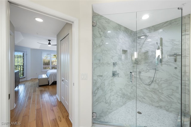 ensuite bathroom with ensuite bath, a marble finish shower, baseboards, and wood finished floors