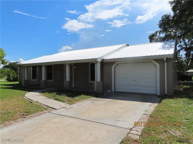 ranch-style house with a garage and a front lawn