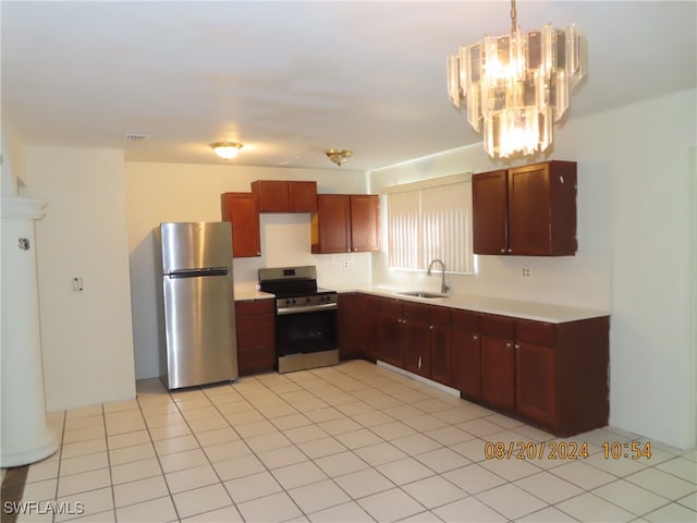 kitchen featuring appliances with stainless steel finishes, light tile patterned floors, sink, and hanging light fixtures