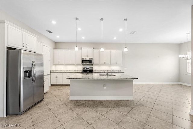 kitchen featuring a sink, visible vents, white cabinetry, appliances with stainless steel finishes, and light stone countertops