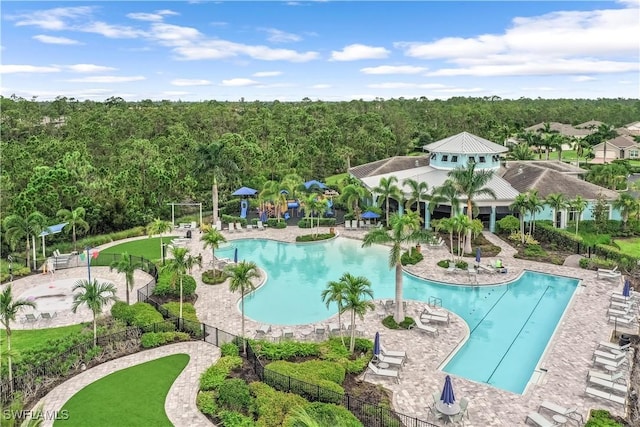 community pool featuring a patio area and fence