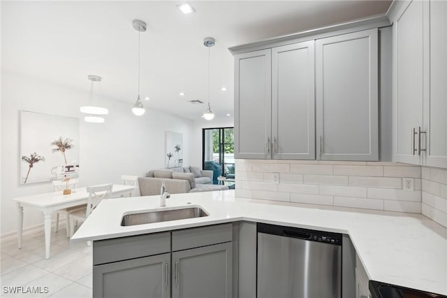 kitchen featuring gray cabinetry, hanging light fixtures, sink, tasteful backsplash, and dishwasher