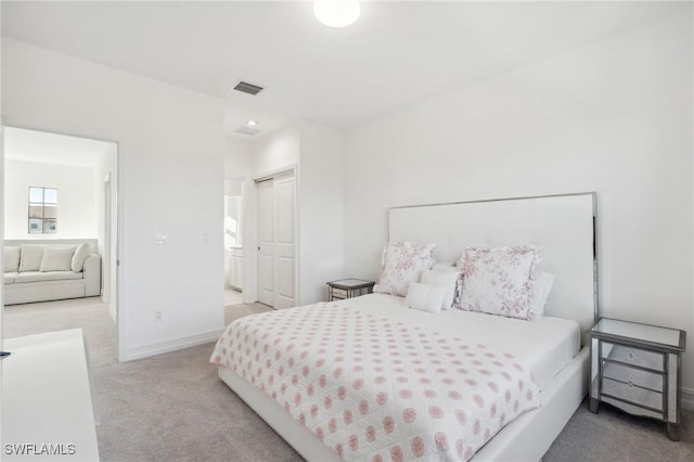 bedroom with light carpet and a closet