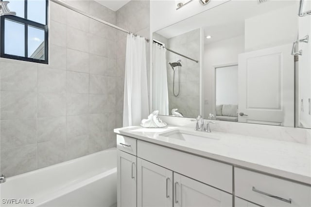 bathroom featuring shower / tub combo with curtain and vanity