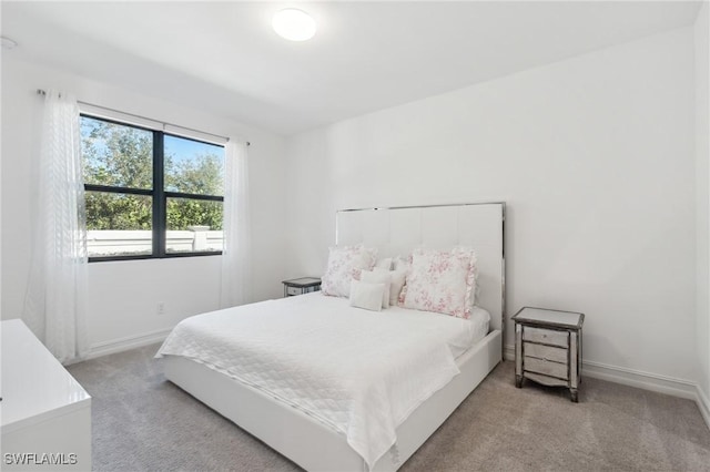 bedroom with light colored carpet