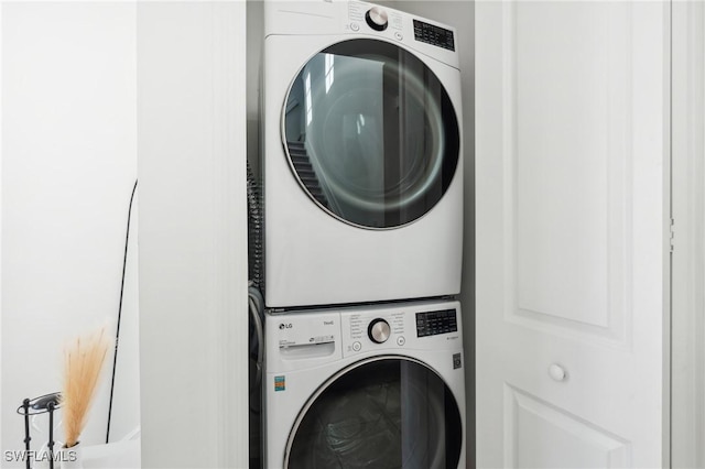 washroom with stacked washer / drying machine