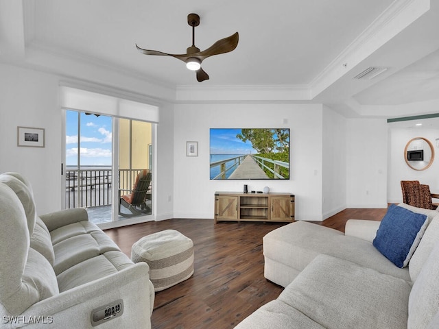 living room with ceiling fan, a raised ceiling, ornamental molding, and dark hardwood / wood-style flooring