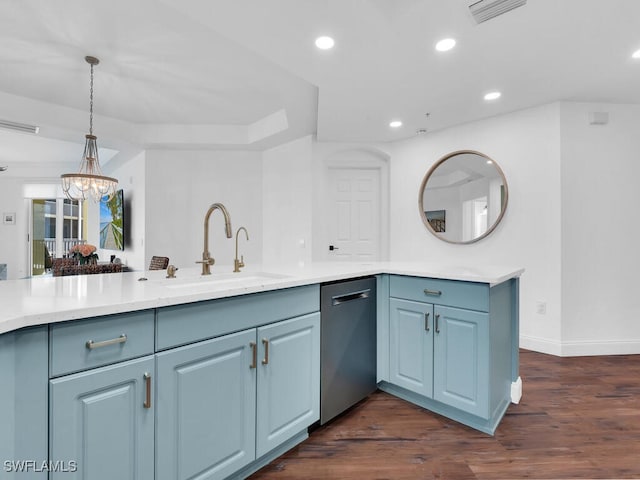 kitchen with dark wood-type flooring, hanging light fixtures, dishwasher, sink, and kitchen peninsula