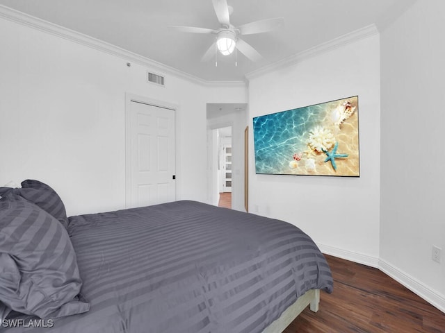 bedroom featuring ceiling fan, ornamental molding, and wood-type flooring