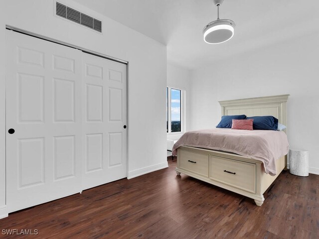 bedroom with a closet and dark hardwood / wood-style floors