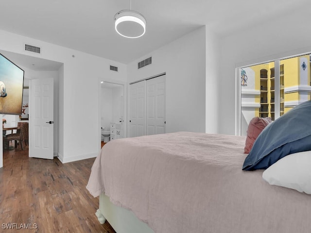 bedroom with wood-type flooring and a closet