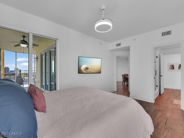 bedroom featuring ceiling fan, dark wood-type flooring, and access to exterior