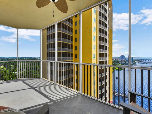 balcony featuring ceiling fan and a water view