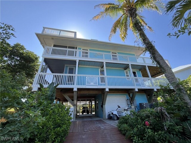 view of front of property with a balcony and a garage