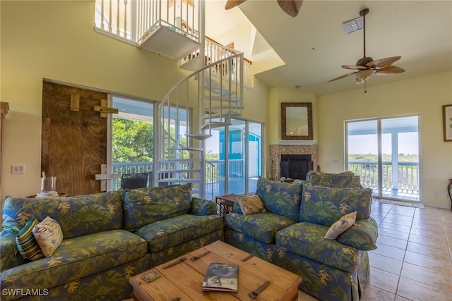 living room with ceiling fan, high vaulted ceiling, and light tile patterned floors