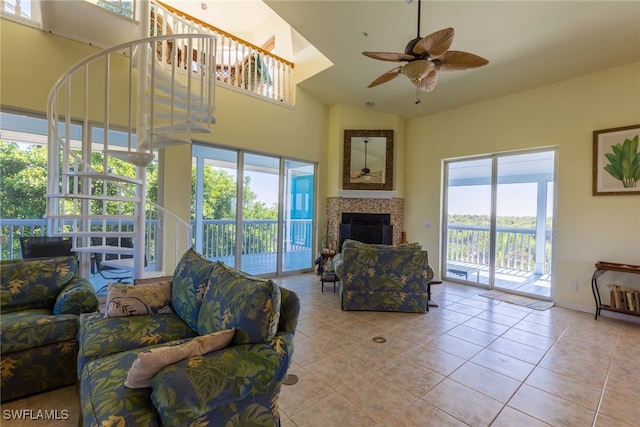 living room featuring light tile patterned flooring, a wealth of natural light, and ceiling fan