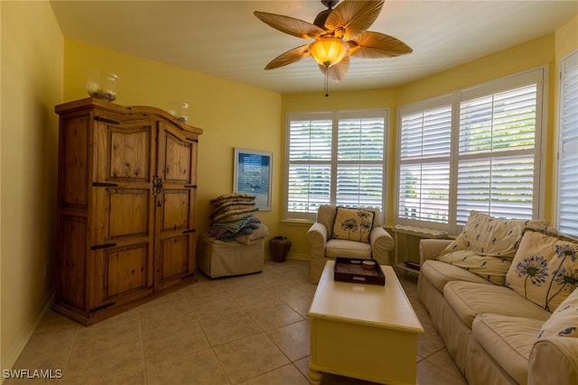 living room with ceiling fan and light tile patterned floors