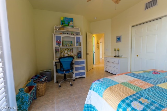 tiled bedroom with a closet and ceiling fan