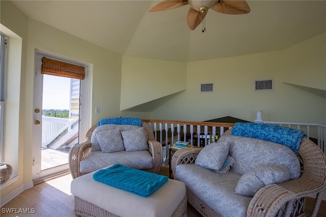 living room with ceiling fan and light hardwood / wood-style flooring