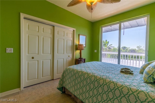 bedroom with ceiling fan, light tile patterned floors, a closet, and access to exterior