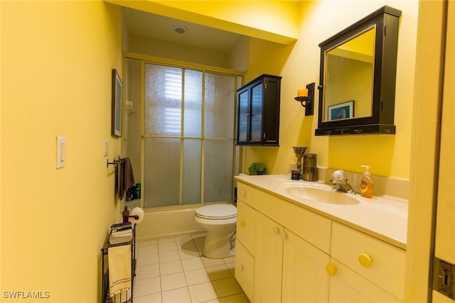 full bathroom with toilet, tile patterned flooring, vanity, and shower / bath combination with glass door