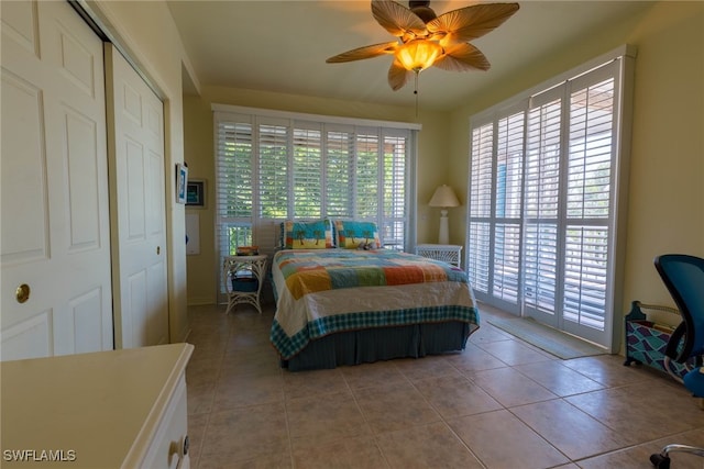 tiled bedroom with ceiling fan, a closet, and access to outside