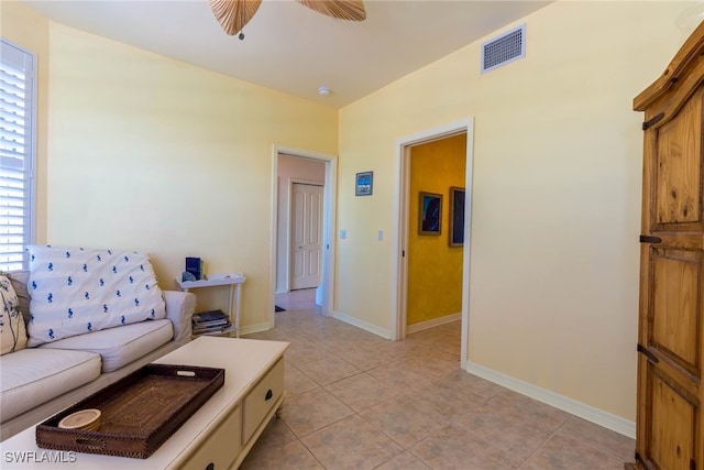 tiled living room featuring ceiling fan