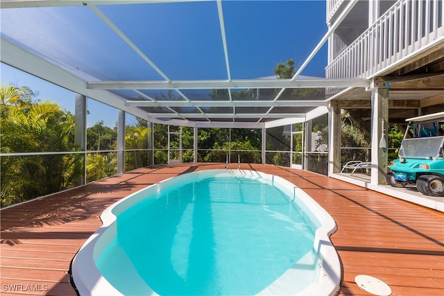 view of swimming pool featuring a lanai