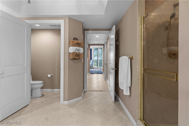 bathroom with toilet, an enclosed shower, and tile patterned floors