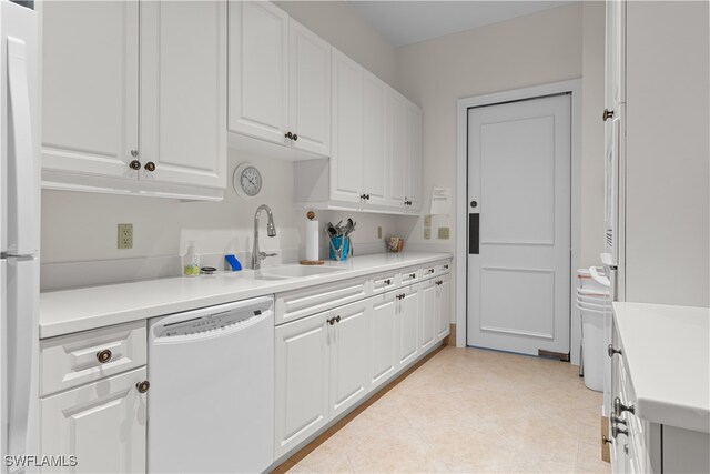 kitchen featuring white appliances, white cabinetry, and sink