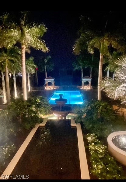 view of pool at night