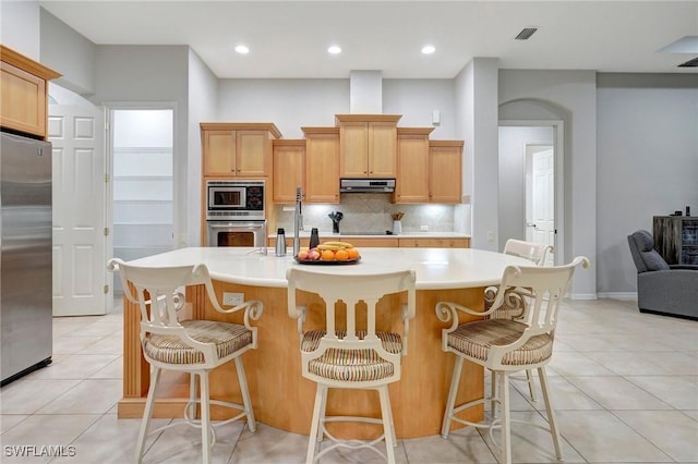 15120 Blackhawk Dr, Fort Myers, FL 33912 - kitchen with appliances with stainless steel finishes, light tile patterned floors, backsplash, light countertops, and recessed lighting