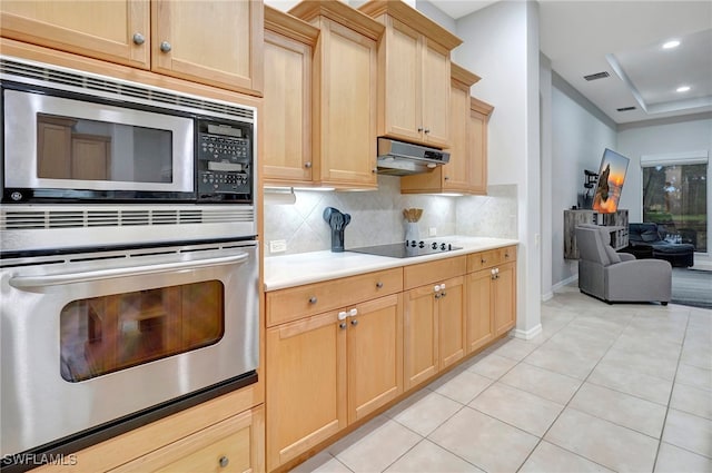 kitchen featuring black appliances, light brown cabinets, decorative backsplash, and light tile patterned floors