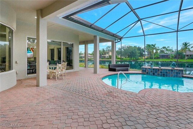 view of pool featuring a lanai, a jacuzzi, a patio, and pool water feature