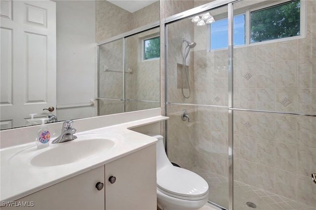 bathroom with vanity, toilet, and walk in shower