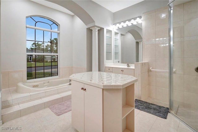 15120 Blackhawk Dr, Fort Myers, FL 33912 - full bathroom featuring tile patterned floors, decorative columns, a stall shower, vanity, and a bath