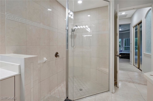 bathroom with tile patterned floors, tiled shower, and vanity